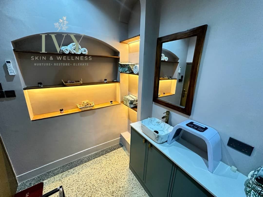 Facial suite with LED light therapy panel and IVY emblem